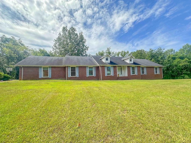 view of front of house with brick siding and a front yard