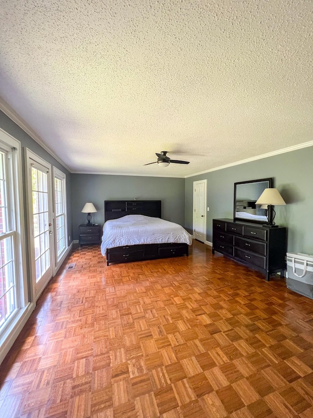 bedroom with a textured ceiling, a ceiling fan, baseboards, and ornamental molding