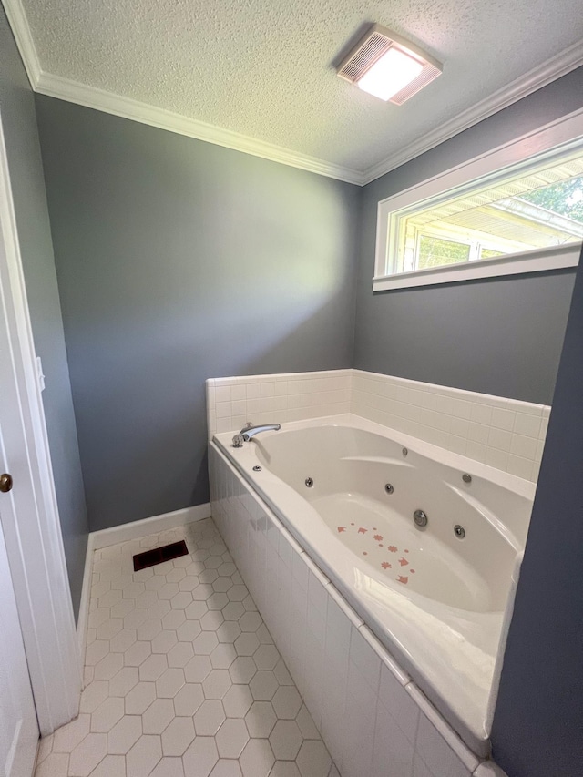 full bath with baseboards, crown molding, a textured ceiling, tile patterned floors, and a jetted tub