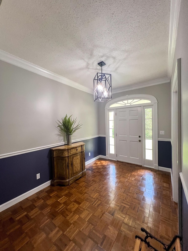 entryway with baseboards, a textured ceiling, an inviting chandelier, and crown molding