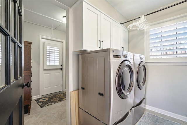 laundry room featuring washer and clothes dryer, cabinet space, attic access, and baseboards