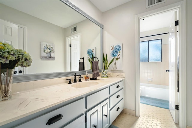 bathroom with visible vents, vanity, and tile patterned flooring