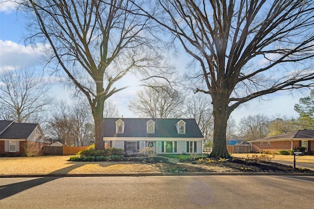 cape cod home with fence