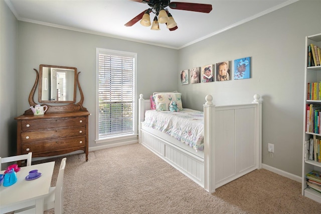 bedroom featuring baseboards, carpet floors, a ceiling fan, and crown molding