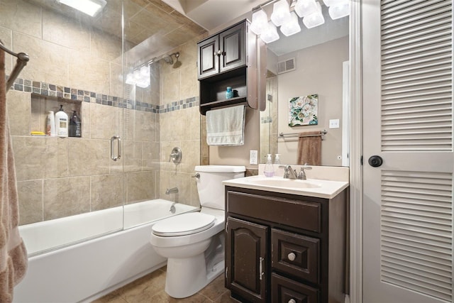 full bathroom with visible vents, toilet, tile patterned flooring, bath / shower combo with glass door, and vanity