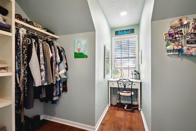 walk in closet with wood finished floors