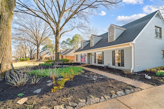 cape cod home with brick siding