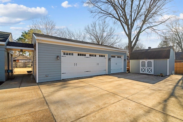 detached garage featuring fence