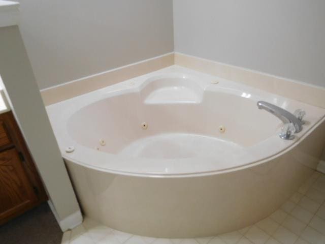 bathroom with a tub with jets