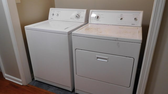 laundry room with laundry area, dark wood-style flooring, and washing machine and clothes dryer