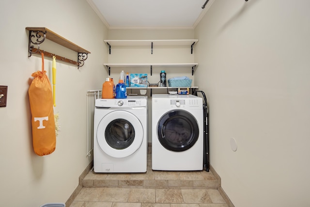 laundry area with baseboards, crown molding, laundry area, and washer and clothes dryer