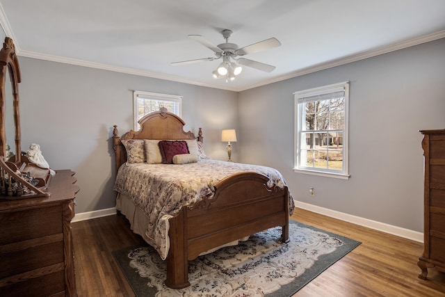 bedroom with baseboards, multiple windows, wood finished floors, and crown molding