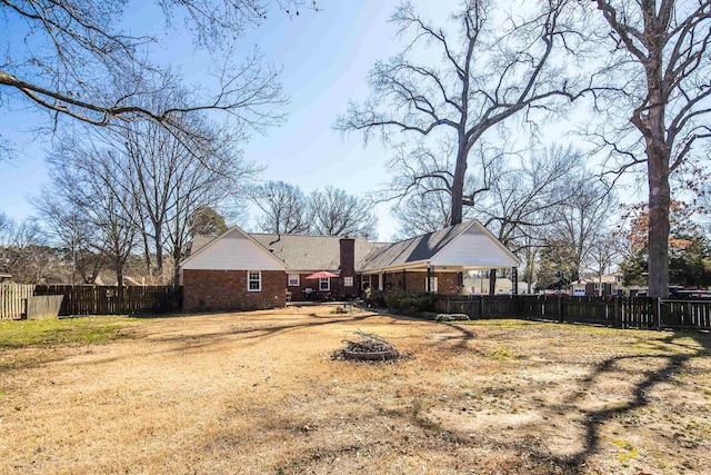 view of yard with fence and a fire pit