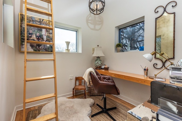 office space with wood finished floors and baseboards