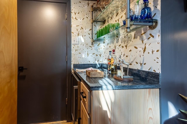 bar featuring wallpapered walls