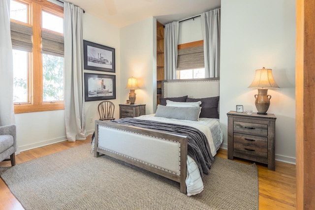 bedroom with wood finished floors and baseboards