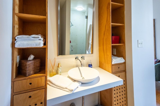 bathroom with a sink and walk in shower