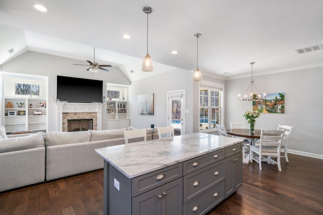 kitchen featuring dark wood-type flooring, gray cabinets, ceiling fan with notable chandelier, and visible vents