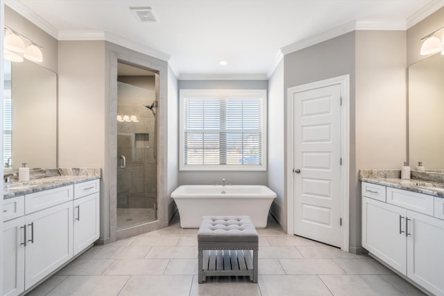 full bathroom with a shower stall, two vanities, and crown molding