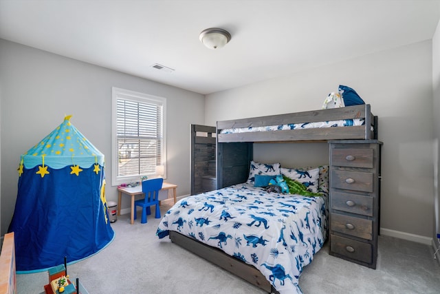 carpeted bedroom with baseboards and visible vents