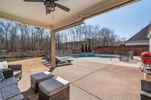 view of patio / terrace with a fenced backyard, a fenced in pool, and ceiling fan