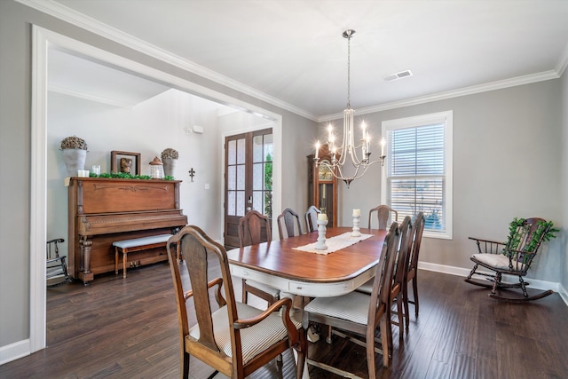 dining area featuring dark wood finished floors, an inviting chandelier, visible vents, and a wealth of natural light