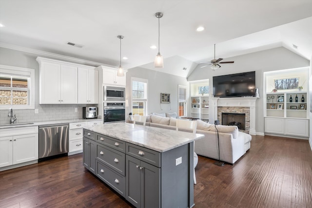 kitchen featuring visible vents, gray cabinetry, appliances with stainless steel finishes, a ceiling fan, and a sink