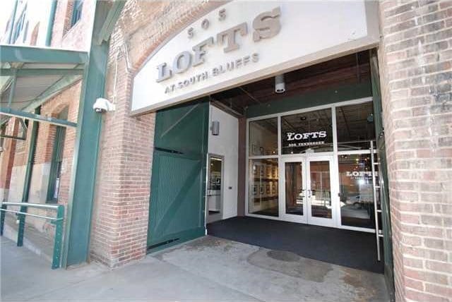 property entrance featuring brick siding and french doors