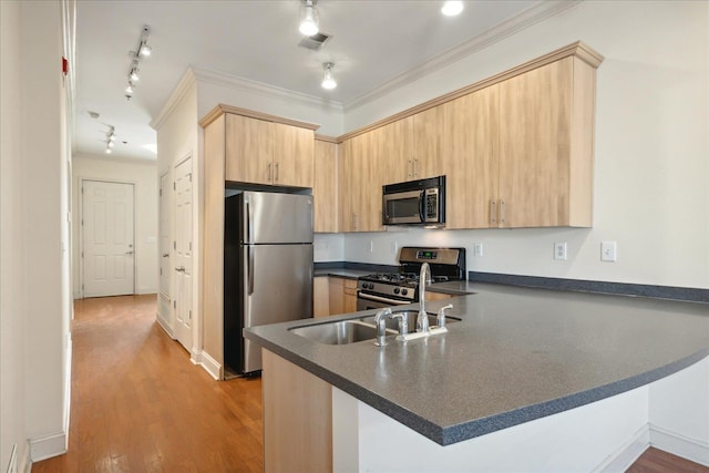 kitchen featuring visible vents, a peninsula, light brown cabinetry, appliances with stainless steel finishes, and dark countertops