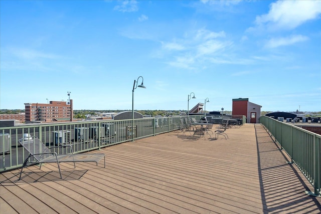 wooden terrace featuring cooling unit