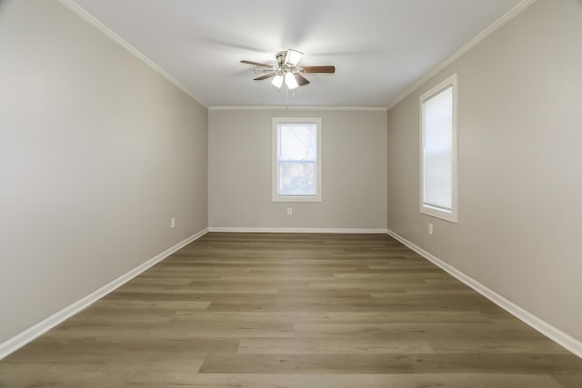 spare room featuring ornamental molding, baseboards, light wood finished floors, and ceiling fan