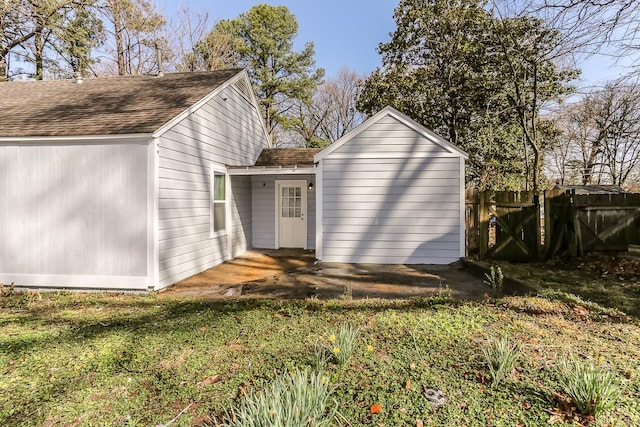 view of outbuilding featuring fence