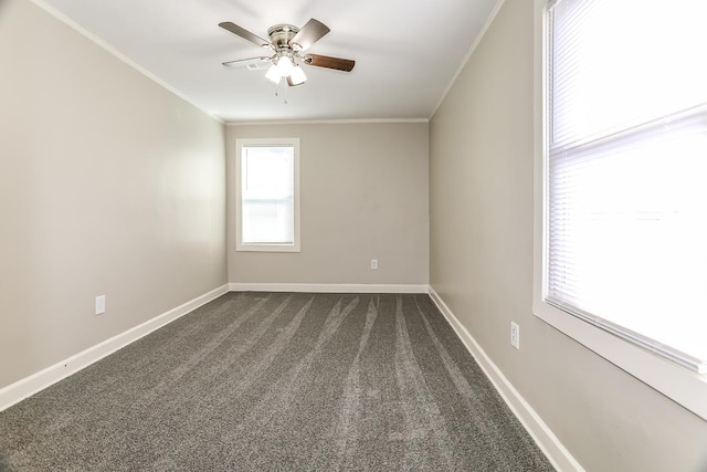 unfurnished room featuring a ceiling fan, baseboards, dark colored carpet, and ornamental molding