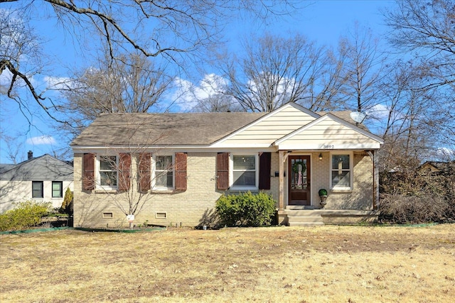 bungalow-style house featuring crawl space, a shingled roof, a front lawn, and brick siding