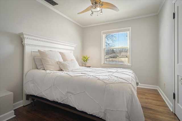 bedroom featuring visible vents, ornamental molding, wood finished floors, baseboards, and ceiling fan