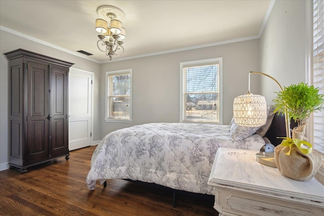 bedroom with visible vents, dark wood-style floors, crown molding, baseboards, and a chandelier