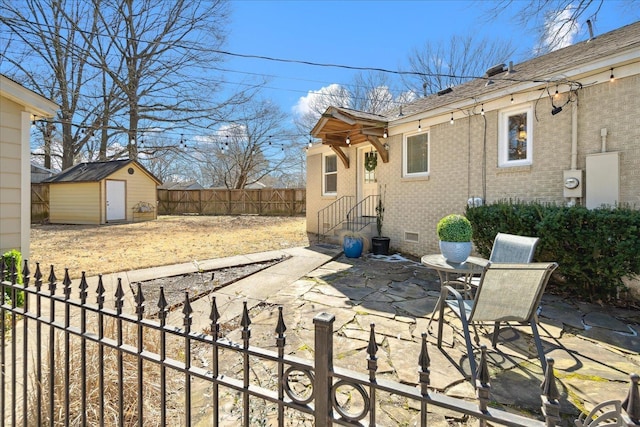 exterior space with an outbuilding, a storage unit, and fence private yard