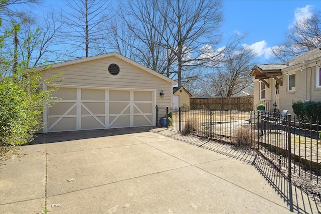 detached garage featuring fence