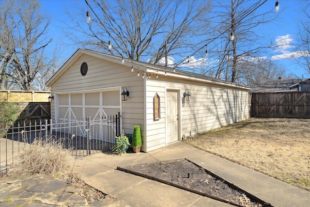 detached garage featuring fence