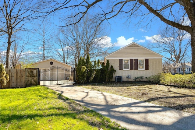 view of side of home with a gate, fence, driveway, central air condition unit, and brick siding