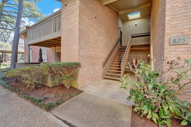 view of exterior entry with brick siding