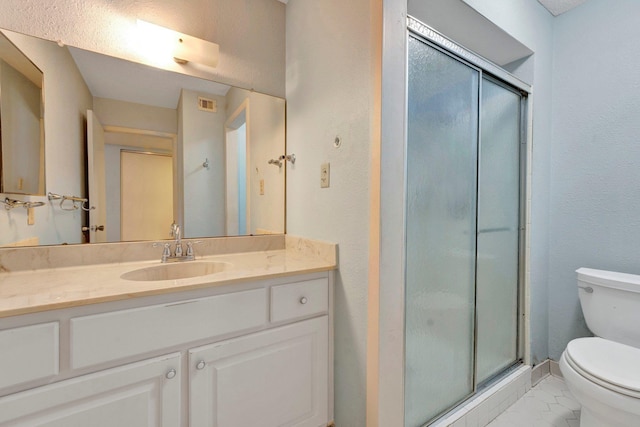 bathroom featuring visible vents, vanity, toilet, and a shower stall