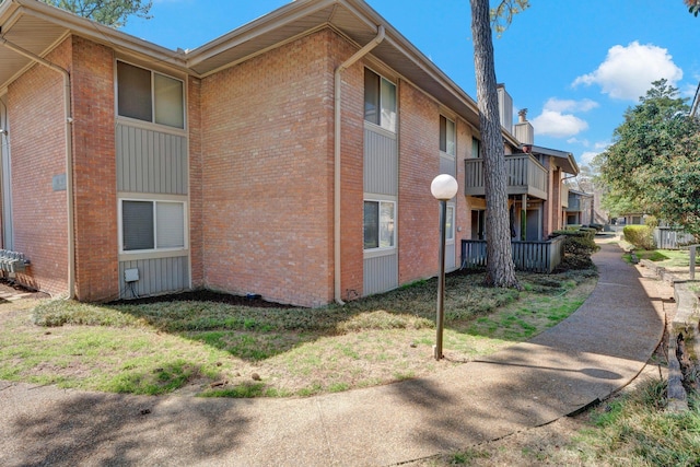 view of side of home with brick siding