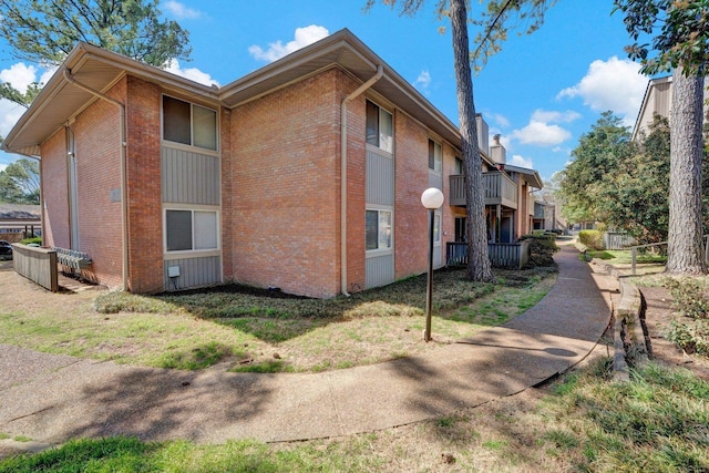 view of property exterior with brick siding