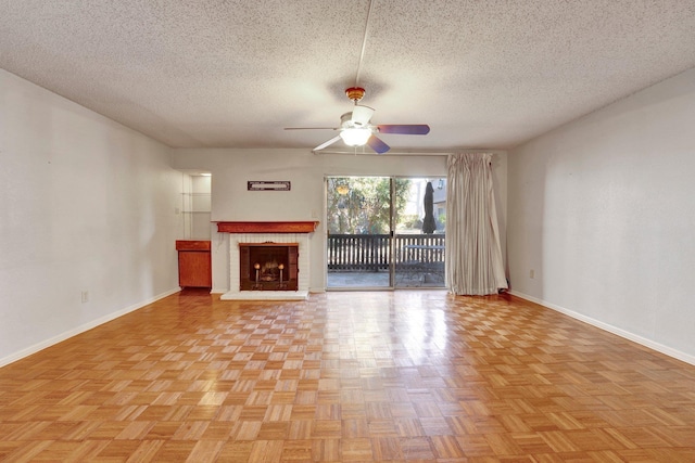 unfurnished living room with baseboards, a textured ceiling, ceiling fan, and a fireplace