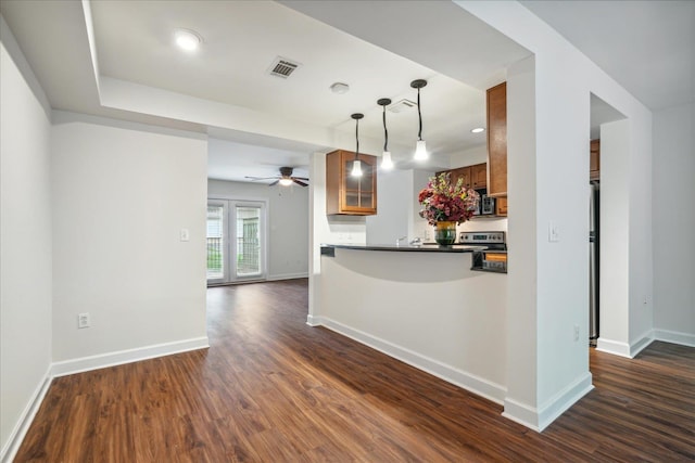 kitchen with visible vents, dark countertops, dark wood-style flooring, and brown cabinetry