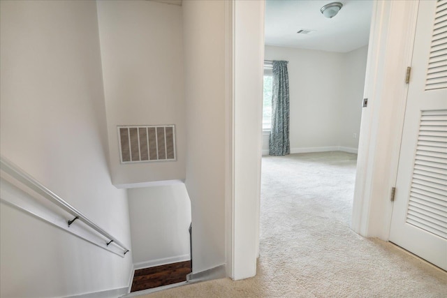 staircase featuring visible vents, baseboards, and carpet