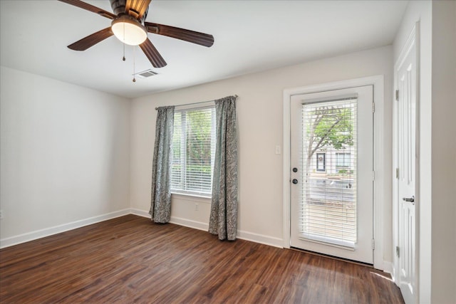 interior space with dark wood finished floors, visible vents, ceiling fan, and baseboards