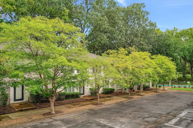 surrounding community featuring uncovered parking and fence