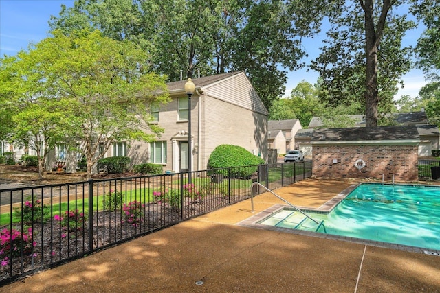 community pool featuring a patio area and fence